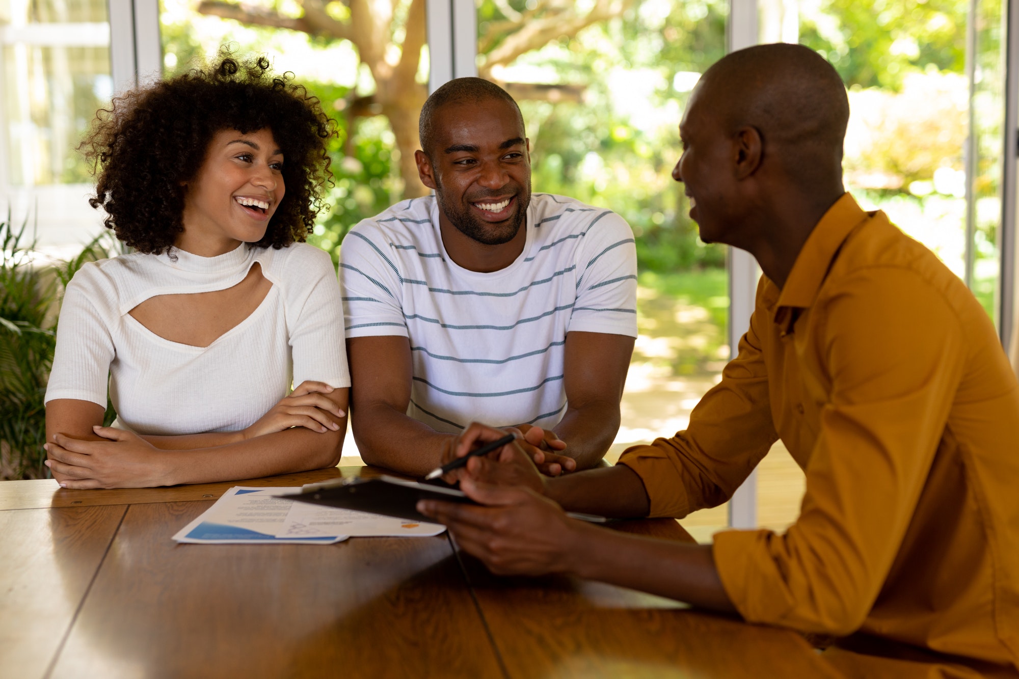 Young couple discussing with a financial adviser